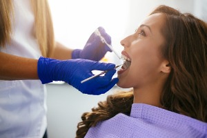 A woman getting a teeth cleaning in Bloomington IL