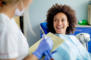 A smiling woman getting ready for a teeth cleaning in Bloomington IL