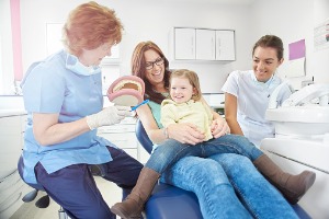 Family in Dental chair smiling in Bloomington IL