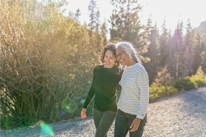 A mother and daughter walk together. In addition to teeth whitening in McLean County IL, Cottage Dental Care also offers Complete Health Dentistry.