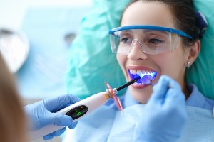 A dental patient opens her mouth during a procedure for Dental Bonding in McLean County IL