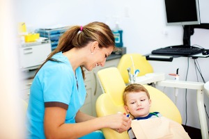 A dental hygenist shows the tools she'll use on a toddler. In addition to Take Home Whitening in McLean County IL, Cottage Dental Care offers pediatric dentistry.